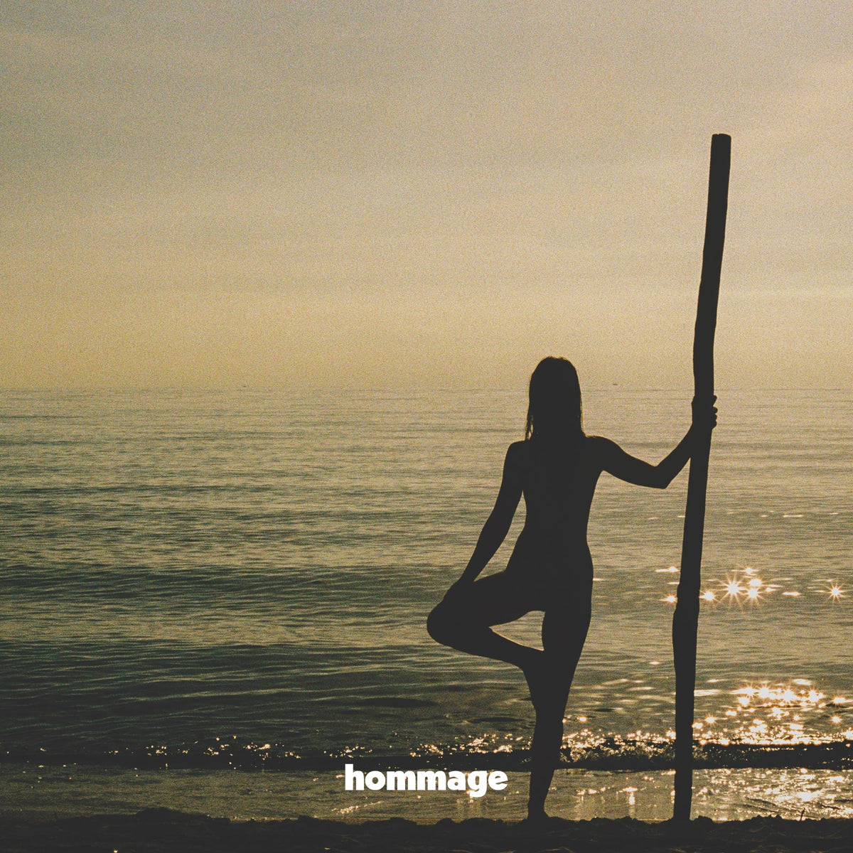 Embrace the serene magic of dawn with 'Dawn's Embrace', a captivating Hommage Art photograph that elegantly portrays the tranquility of the ocean's embrace at daybreak.